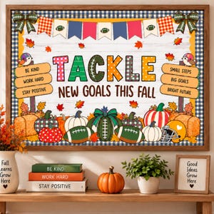 May include: A framed classroom bulletin board display featuring the text TACKLE NEW GOALS THIS FALL, decorated with footballs, pumpkins, hay bales, autumn leaves, and pennant banners. Two wooden signs list motivational phrases on a white wood background.