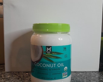 May include: A clear jar of Member's Mark Organic Coconut Oil with a green lid. The label features a coconut illustration and text: "COCONUT OIL ORGANIC & VIRGIN". The jar contains 56 fl oz of cold-pressed, unrefined coconut oil.