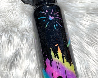 May include: Black glitter water bottle with a rainbow glitter design of Cinderella's castle and fireworks with Mickey Mouse silhouettes.