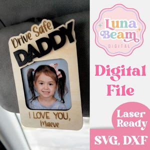 May include: Wooden car visor accessory with the words "Drive Safe DADDY" and a photo of a young girl. The text "I LOVE YOU, Maeve" is below the photo. The accessory is attached to a car visor.