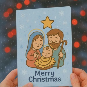 May include: A light blue Christmas card featuring a cartoon illustration of the Nativity scene. The card shows Mary, Joseph, and baby Jesus, with a gold star above them and the words "Merry Christmas" below.