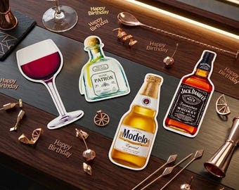 May include: A bar scene with a cocktail in a stemmed glass, drink cutouts, and bar tools. Cutouts include a wine glass, tequila, beer, and whiskey bottles. The words "Cheers to Birthday" are in the background, with "Happy Birthday" scattered around.