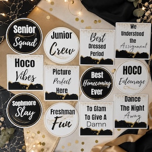 May include: A collection of twelve circular and square signs featuring black, white, and gold accents. The text includes phrases such as Senior Squad, Junior Crew, Best Dressed Period, We Understood the Assignment, Hoco Vibes, Picture Perfect Here, Best Homecoming Ever, HOCO Entourage, Sophmore Slay, Freshman Fun, To Glam To Give A Damn, and Dance The Night Away.