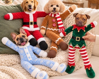 May include: Four plush toys featuring dog heads on stuffed bodies dressed in holiday outfits: a Santa suit, a gingerbread person with a scarf, a blue snowflake-patterned pyjama set, and a green elf costume with red and white striped leggings.