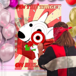 May include: A party game featuring a cartoon dog with a target on its head. The game is called "Pin the Target on Bull". A person wearing a red bandana is attempting to place the target on the dog. Balloons in various colors are in the background.