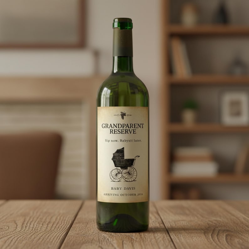 May include: A green wine bottle with a label that reads "Grandparent Reserve." The label features a vintage baby carriage illustration and the text "Sip now, Babysit later." The bottle is on a wooden surface.