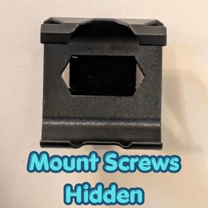 May include: A black metal bracket with a rectangular shape and a hexagonal opening. The bracket has a textured surface and the text "Mount Screws Hidden" in a blue and white font.