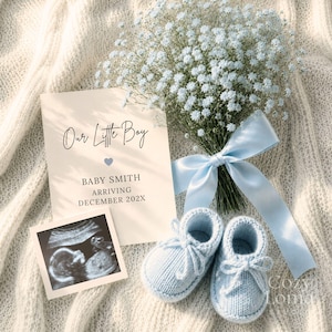 May include: A cream-colored announcement card with the text Our Little Boy, BABY SMITH, ARRIVING DECEMBER 202X, a small blue heart, a black and white ultrasound print, light blue baby booties, and a bouquet of baby's breath tied with a blue ribbon.