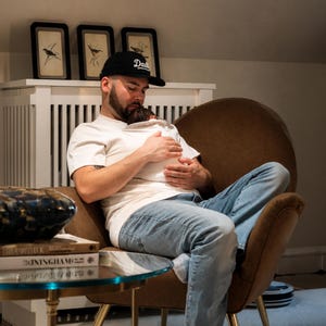May include: A black baseball cap with the word Daddy embroidered in white script, a white short-sleeved t-shirt, and light blue denim jeans. The cap features a curved brim and an adjustable strap, while the t-shirt has a crew neckline.