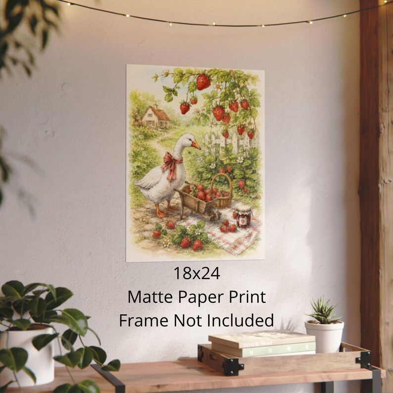 May include: A matte paper print, 18x24 inches, featuring a charming illustration of a goose with a red bow, a cart of strawberries, and a jar of jam. The scene is set in a garden with a white picket fence and a small house.