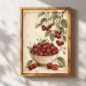 May include: A framed print featuring a watercolor illustration of cherries. A white bowl filled with ripe red cherries sits below a branch laden with cherries and green leaves. The background is a vintage-style parchment.