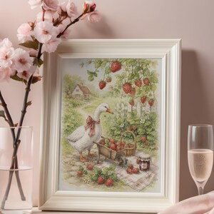 May include: A framed print depicts a goose with a red bow, a wheelbarrow, and a basket filled with strawberries. The artwork features a white picket fence, a small house, and strawberry plants. The frame is white.