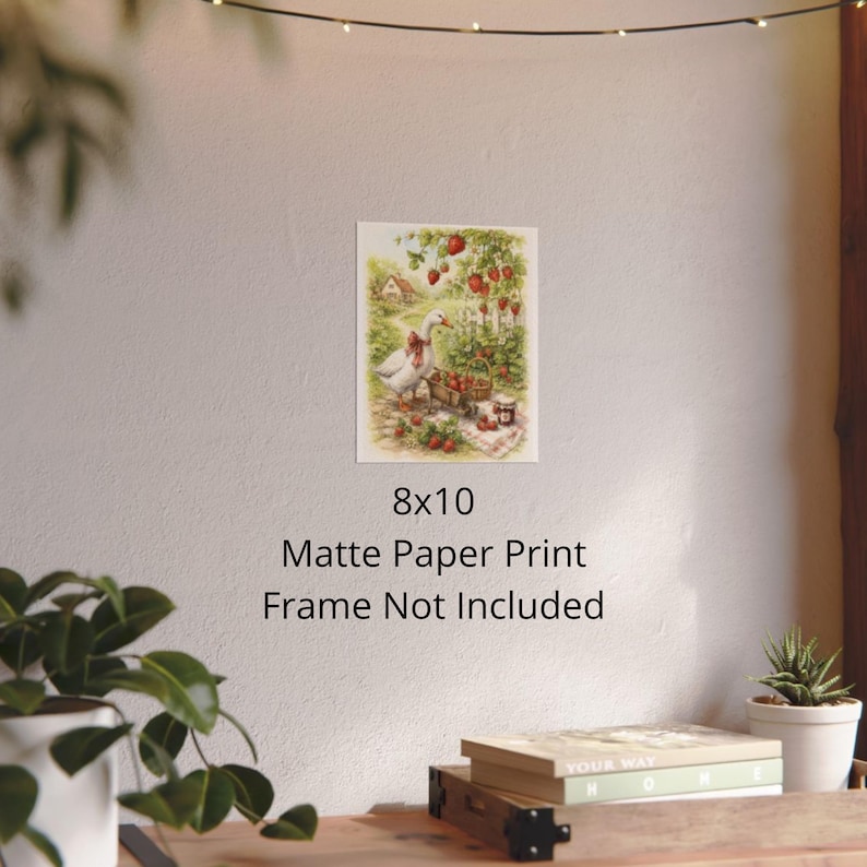 May include: An 8x10 matte paper print featuring a charming illustration of a goose with a red bow, a cart of strawberries, and a jar of jam. The artwork is set in a garden with a small house in the background. The text "Frame Not Included" is below the image.