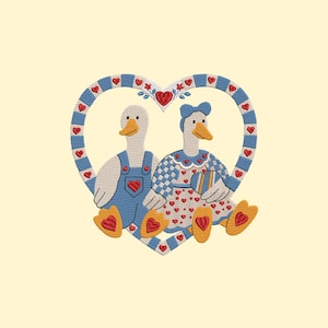 May include: Embroidered design featuring two geese inside a heart-shaped frame. One goose wears blue overalls with a heart pocket, the other a blue dress with a heart pattern. The heart frame is blue with red hearts.