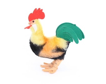 May include: A plush toy rooster with a red comb and wattle, yellow and black feathers, and a green felt tail.