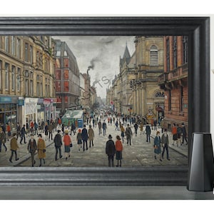 May include: A framed print showing a busy street scene. The artwork features a wide street filled with people, lined by buildings with shops and architectural details. The colour palette is muted, with browns, greys, and reds dominating the scene.