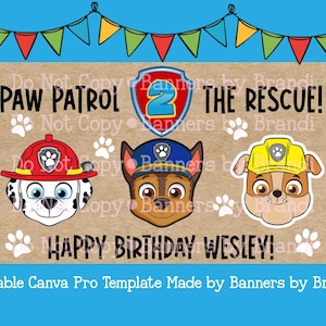 Op de afbeelding: Een rechthoekige verjaardagsbanner met een bruine textuurachtergrond en kleurrijke vlaggetjes aan de bovenkant. Het toont de tekst PAW PATROL 2 THE RESCUE! en HAPPY BIRTHDAY WESLEY! met illustraties van drie cartoonhonden.