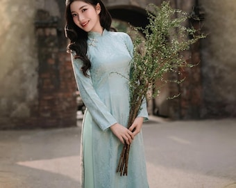 Ao Dai modernizado de silueta recta con estampado de murciélago, confeccionado en tela de seda arrugada y adornado con elegantes y lujosos botones de perlas.