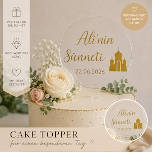 May include: A clear acrylic cake topper with gold lettering that reads "Ali'nin Sünneti" and the date 22.06.2026. The topper features a mosque silhouette and is placed on a decorated cake with flowers.