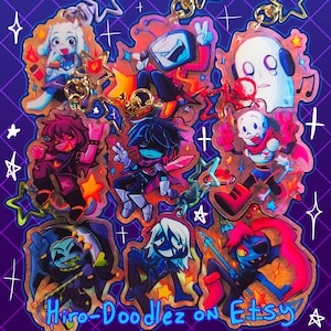 May include: A collection of nine colorful acrylic keychains featuring various cartoon characters in dynamic poses, including a television-headed figure, a skeleton, and a ghost, all attached to gold star-shaped clasps against a purple grid background.