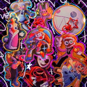May include: A collection of colorful, cartoon-style acrylic charms featuring various characters. The charms have gold-colored edges and are attached to red key rings. The background is black with a neon purple and blue design.