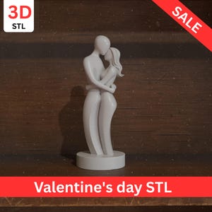 May include: A white sculpture of a couple embracing, with the words "Valentine's day STL" at the bottom. The sculpture is on a round base and set against a dark wood background. The word "SALE" is in red.