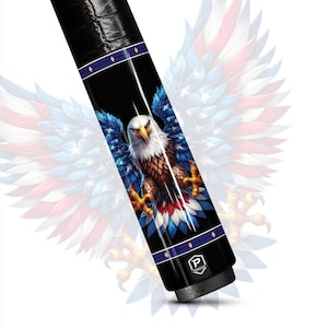 May include: A black pool cue with a detailed graphic of an American bald eagle with outstretched wings. The eagle is depicted with blue, white, and red feathers against a black background. The cue has a leather grip and decorative blue bands.