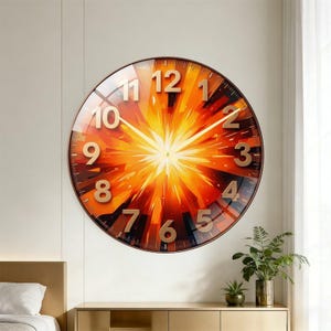 May include: A round wall clock featuring a vibrant sunburst design in shades of orange, yellow, and deep red. The clock face displays large, raised gold-toned numerals from 1 to 12 and thin gold-toned hour, minute, and second hands.