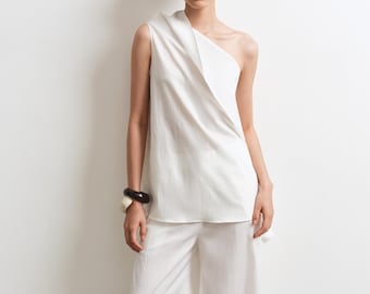 Conjunto de top Cascade y pantalón con aberturas laterales: elegancia asimétrica moderna.