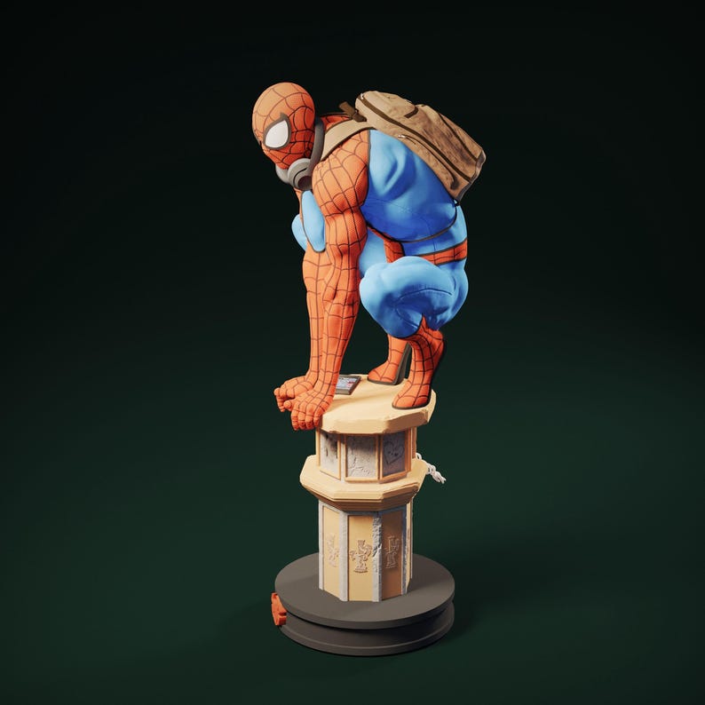May include: A detailed figurine of Spider-Man in a crouching pose, wearing his signature red and blue suit, a backpack, and a mask. The figure is perched atop a decorative, beige column with intricate carvings. The base is dark gray.