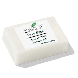 May include: A rectangular block of transparent soap base with a white label. The label reads "NATURON" and "Soap Base" with the words "Melts & Pour Transparent" below. The net weight is 500g.
