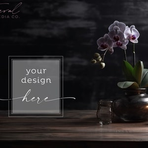 May include: A dark wooden table with a vase of white orchids, a clear glass jar, and a candle in a glass holder. The text "your design here" is in a gray box on the table.