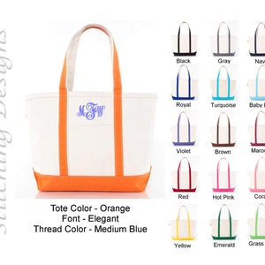 May include: A white canvas tote bag with orange trim and a blue monogram. The bag is shown with a variety of thread color options.
