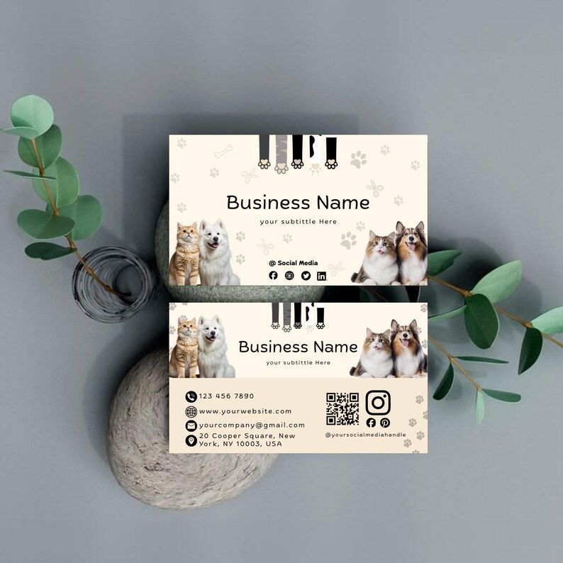 May include: A rectangular business card template with a cream background featuring a cat and dog photo, paw print patterns, and black text. The design includes placeholders for a business name, contact details, social media icons, and a QR code.