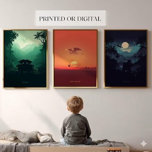May include: Three framed art prints with gold frames. The prints depict stylized landscapes in shades of green, orange, and blue. The text "PRINTED OR DIGITAL" is above the prints. A child is sitting on a bed, looking at the art.