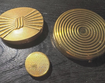 Vintage VTG Tres polveras de metal en tono dorado de Dorset Fifth Ave, Luxor y Evans