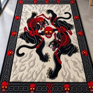 May include: A rectangular area rug featuring two black panthers with red skeletal overlays, a central red skull, and a border decorated with a chain pattern and red skulls. The background is a cream color with a light gray flame and arrow motif.