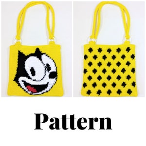 Puede incluir: Una bolsa de mano de crochet amarilla con una cara de gato de dibujos animados en blanco y negro en un lado y un patrón de lunares negros y amarillos en el otro lado. La bolsa tiene asas blancas.