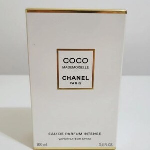 May include: White rectangular box with gold trim. The box features the text "COCO MADEMOISELLE CHANEL PARIS" in a gold-bordered rectangle. Below, it reads "EAU DE PARFUM INTENSE VAPORISATEUR SPRAY". The box also indicates 100 ml and 3.4 FL.OZ.