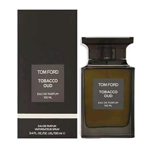 May include: A rectangular perfume bottle and box set. The bottle and box are dark brown with the words "TOM FORD TOBACCO OUD EAU DE PARFUM 100 ML" printed on them. The bottle contains a light brown liquid. The box also says "EAU DE PARFUM VAPORISATEUR SPRAY 3.4 FL. OZ/OZ. LIQ/100 ml e".