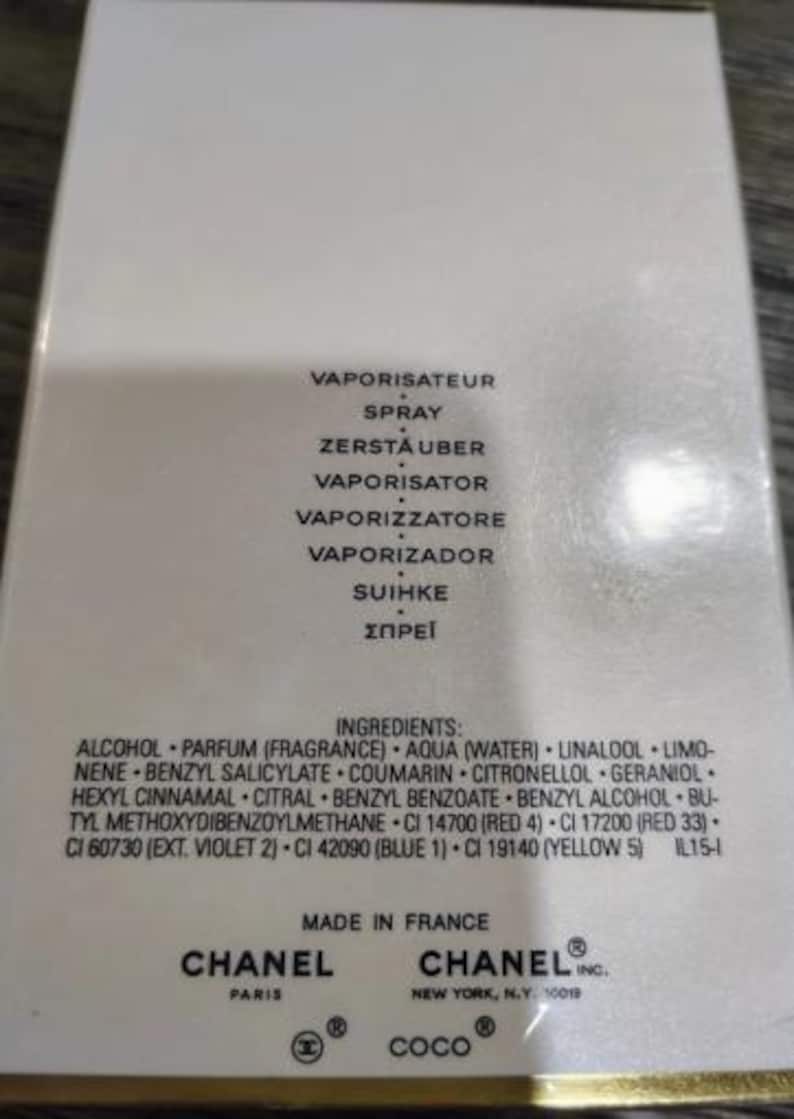 May include: A close-up of a white perfume box with black text. The box lists ingredients and phrases like "VAPORISATEUR" and "SPRAY". The Chanel logo is visible, along with "MADE IN FRANCE" and "COCO".