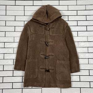 May include: A brown duffel coat with a hood and toggle fastenings. The coat features two front pockets and a textured finish. The coat is made of a thick, warm material, suitable for cold weather.