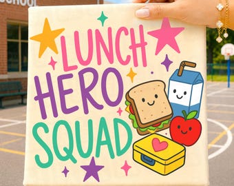 May include: A square sign with a cream background featuring the text LUNCH HERO SQUAD in pink, purple, and teal. The design includes a smiling sandwich, a blue milk carton, a red apple, and a yellow lunchbox, accented by colorful stars.