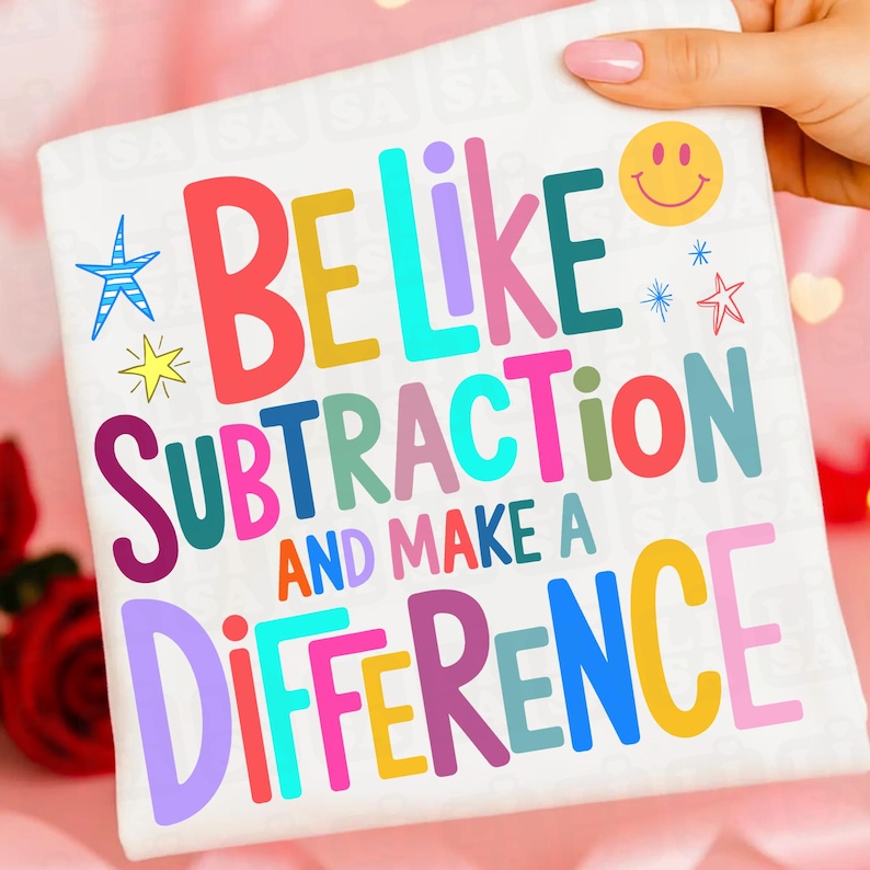 May include: A white square textile with the words "BE LIKE SUBTRACTION AND MAKE A DIFFERENCE" in colorful block letters. The design includes a smiley face, stars, and a starburst.