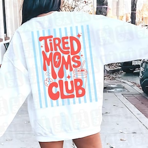 Può includere: Felpa bianca con un design retrò che recita "Tired Moms Club" in lettere rosse. Il design include una bevanda, un biscotto e uno sfondo a righe blu. Un top casual e confortevole.