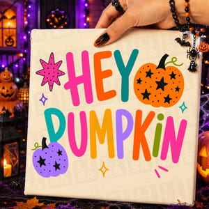 May include: A square canvas sign featuring the colorful text HEY PUMPKIN in a bold, playful font. The design includes a bright orange pumpkin with black stars, a purple pumpkin with black stars, a pink starburst, and small yellow star accents.