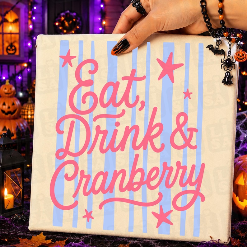 May include: A square canvas sign featuring a cream background with vertical light blue stripes. The text Eat, Drink & Cranberry is printed in a bold pink script font, accented by several pink star shapes scattered across the surface.