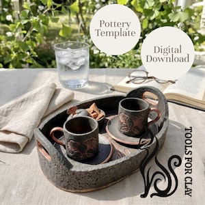 May include: A handmade pottery tray with two small cups and saucers. The cups and tray are dark gray with copper-colored accents. The cups feature a leaf design. A glass of water and a book are also on the table. The text "Pottery Template" and "Digital Download" are in the image.