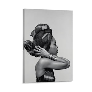 May include: Monochrome portrait of a person wearing a patterned head wrap and jewellery. The person is seen in profile, with their hands gently touching the head wrap. The image is a canvas print.