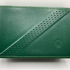 May include: A set of three ceramic mugs with a speckled, cream-colored glaze. Each mug features a different hand-painted floral design in shades of blue, green, and yellow. The mugs have a simple, rounded shape and a comfortable handle.